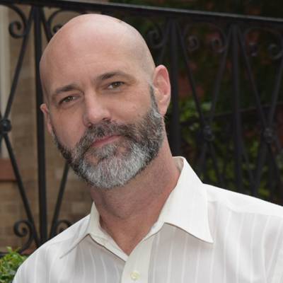 Richard Bargdill, Ph.D., in front of iron fence