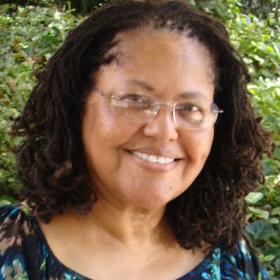 Faye Belgrave, Ph.D., in front of greenery