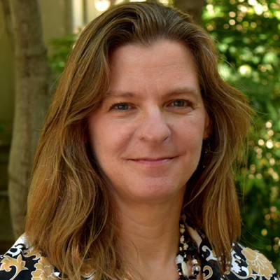 Ellen Carpenter, Ph.D., in front of greenery