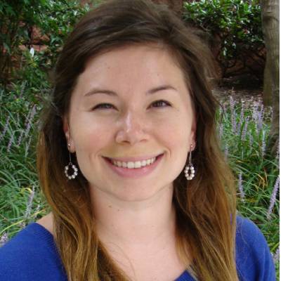 Caroline Cobb Ph.D., in front of greenery