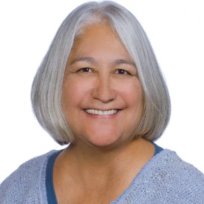 Rosalie Corona, Ph.D., in front of a white screen