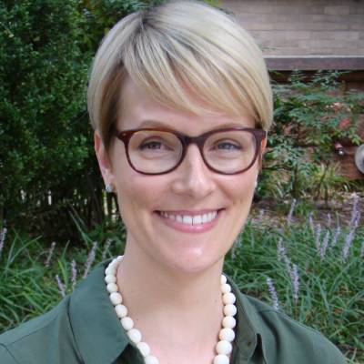 Natalie Dautovich, Ph.D., in front of greenery