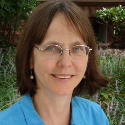 Sandra Gramling, Ph.D., in front of greenery