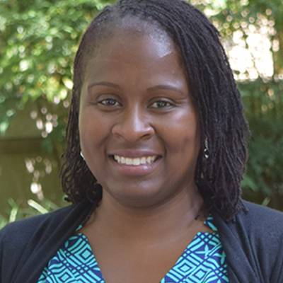 Kristina Hood, Ph.D., in front of greenery