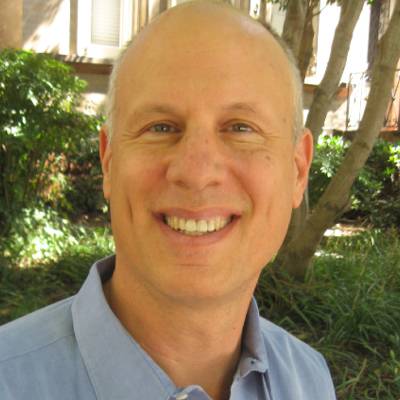 Bruce Rybarczyk, Ph.D., in front of greenery