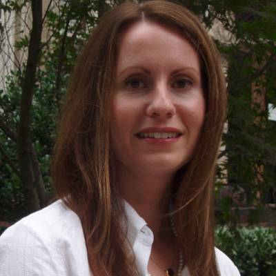 Linda Zyzniewski, Ph.D., in front of greenery